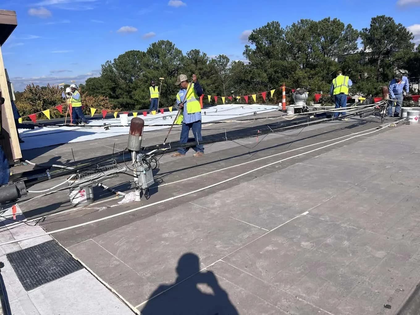 Commercial roofing crew working on a flat roof system