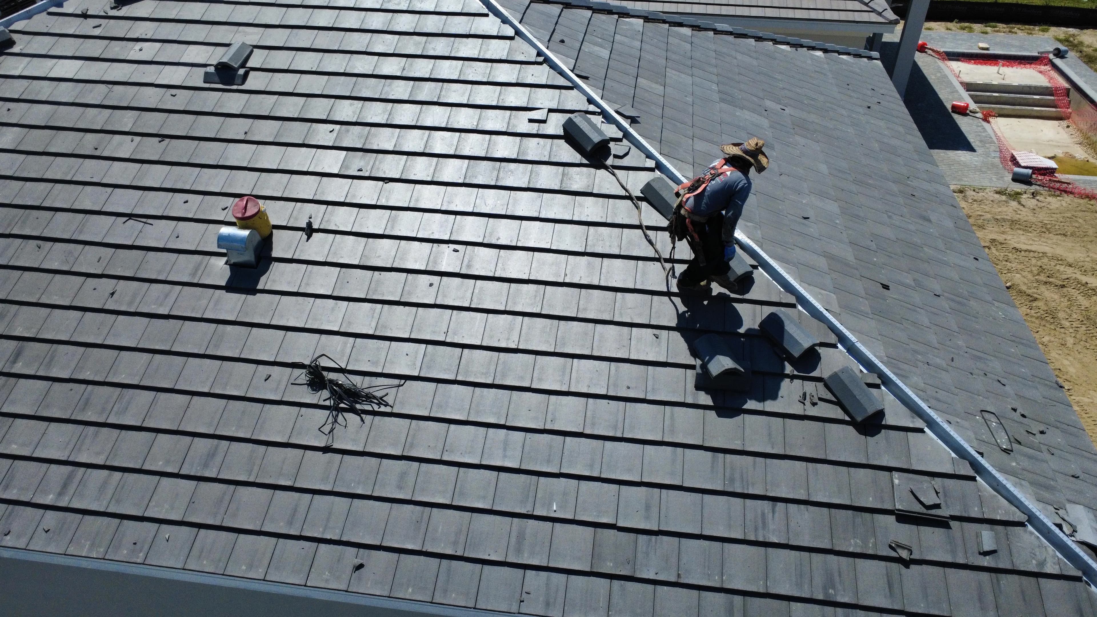 Roofing crew following the installation plan on a Fort Worth home