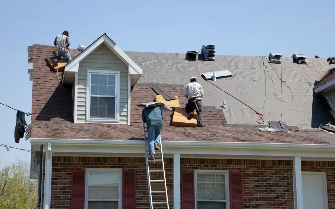 Roofing crew working above an occupied residential home