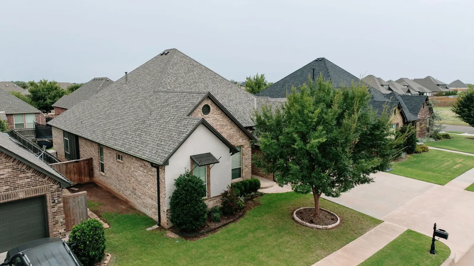 Aerial view of a completed shingle roof in a Fort Worth neighborhood
