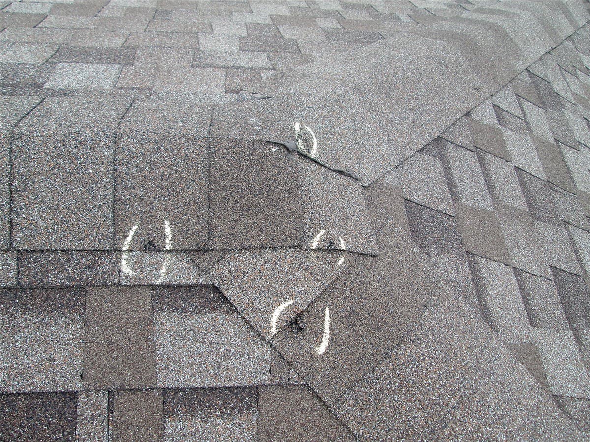 Storm damage around roof shingles and flashing
