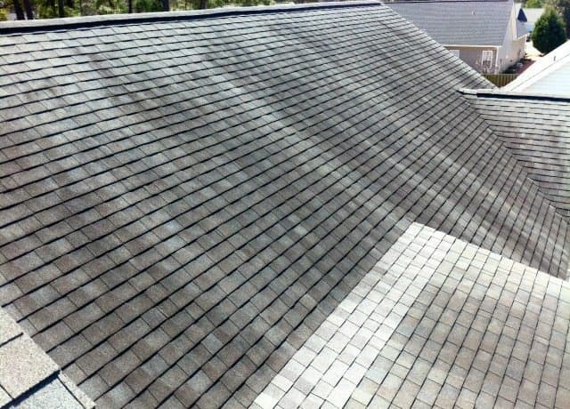 Roof valley being inspected while tracing a leak path